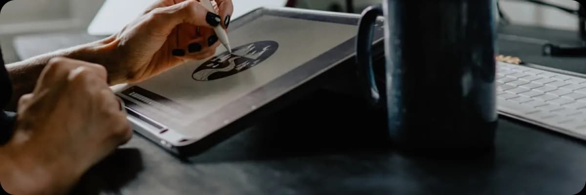 Designer working on a tablet with a stylus in a creative studio